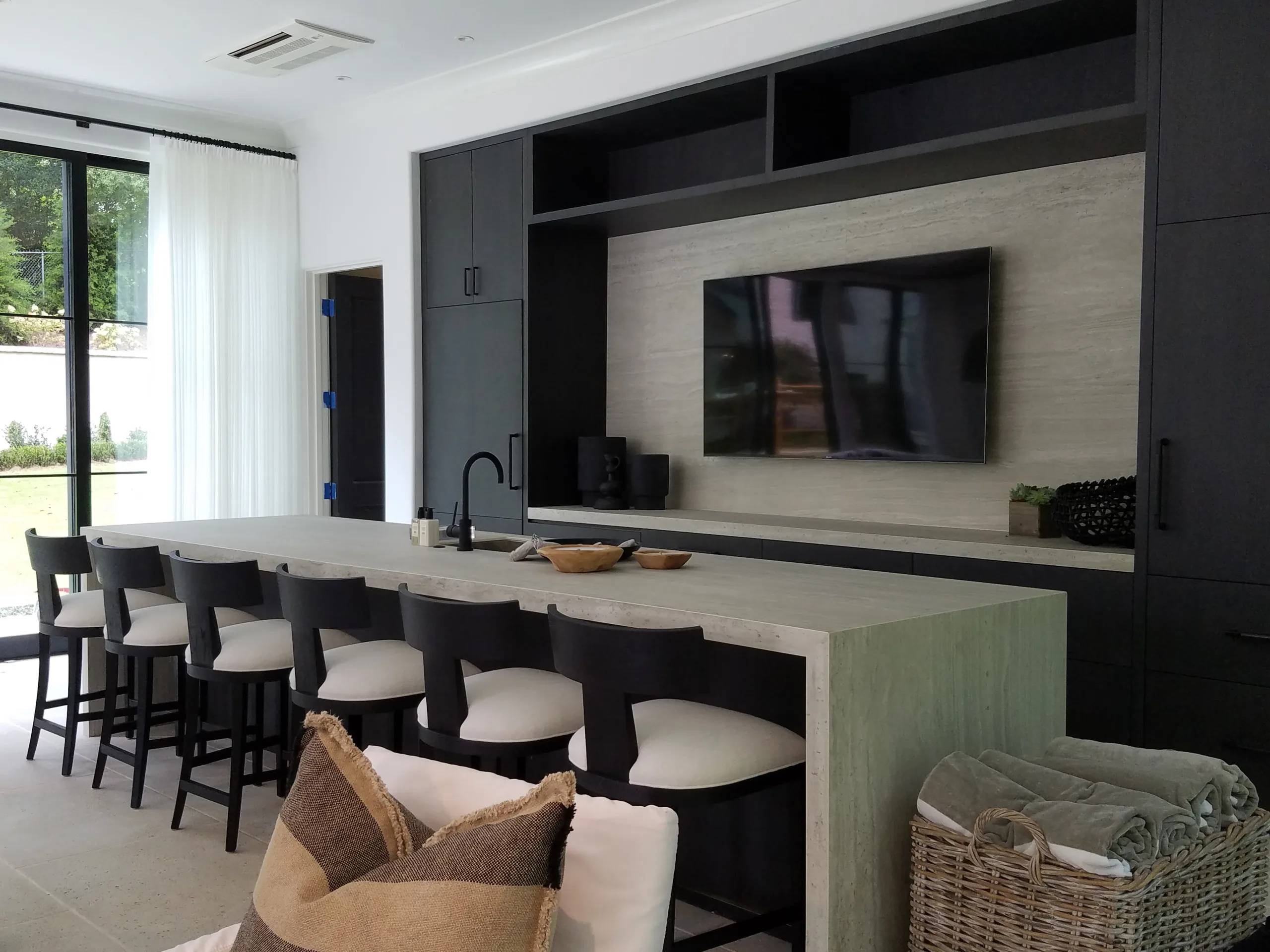 Kitchen12 A room with a bar and a television.