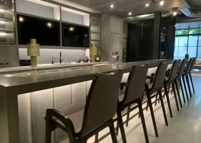 A bar with chairs in a room.